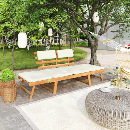 Garden bench with cushions in a lush outdoor setting, perfect for relaxing or lounging on the patio.