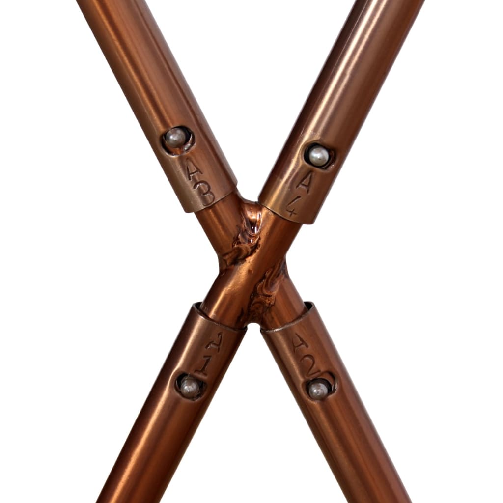 Close-up of the copper frame joint of a butterfly chair, showcasing its sturdy construction and design.