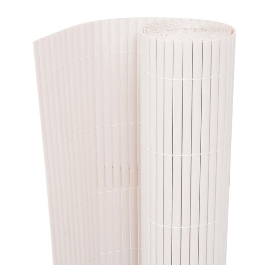 Double-sided white garden fence rolled up, made of durable weather-resistant PVC for outdoor use.