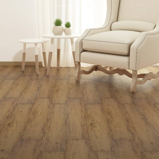 Self-adhesive PVC flooring planks in a spacious living room with a beige armchair and decorative side table.