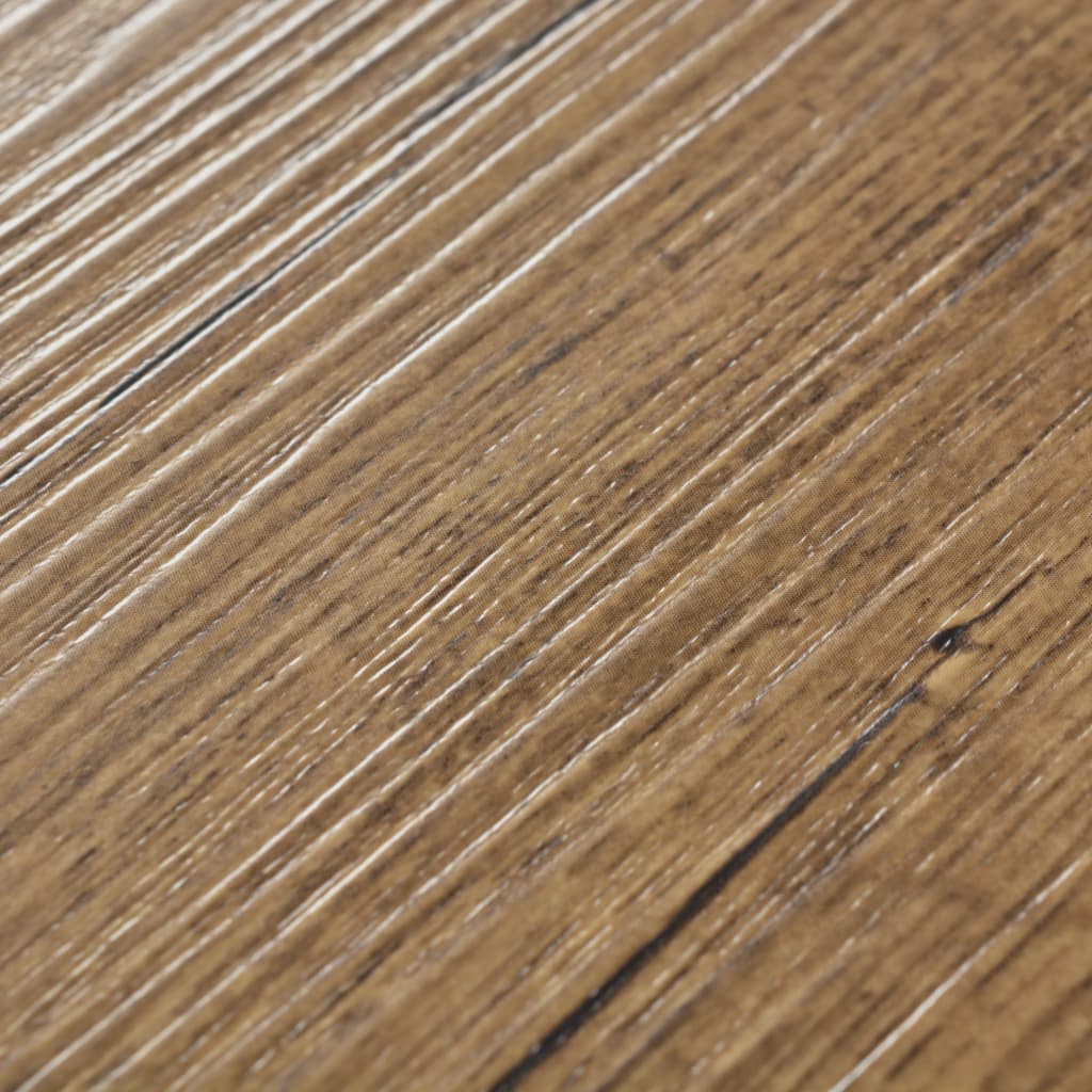 Close-up of walnut brown self-adhesive PVC flooring planks, showcasing texture resembling natural wood.