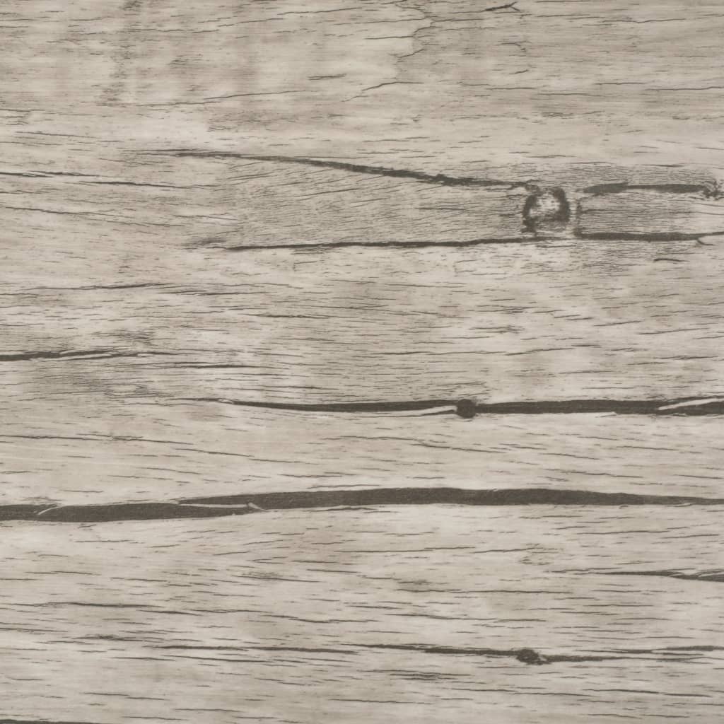 Close-up of self-adhesive PVC flooring planks in oak washed design with natural wood texture.