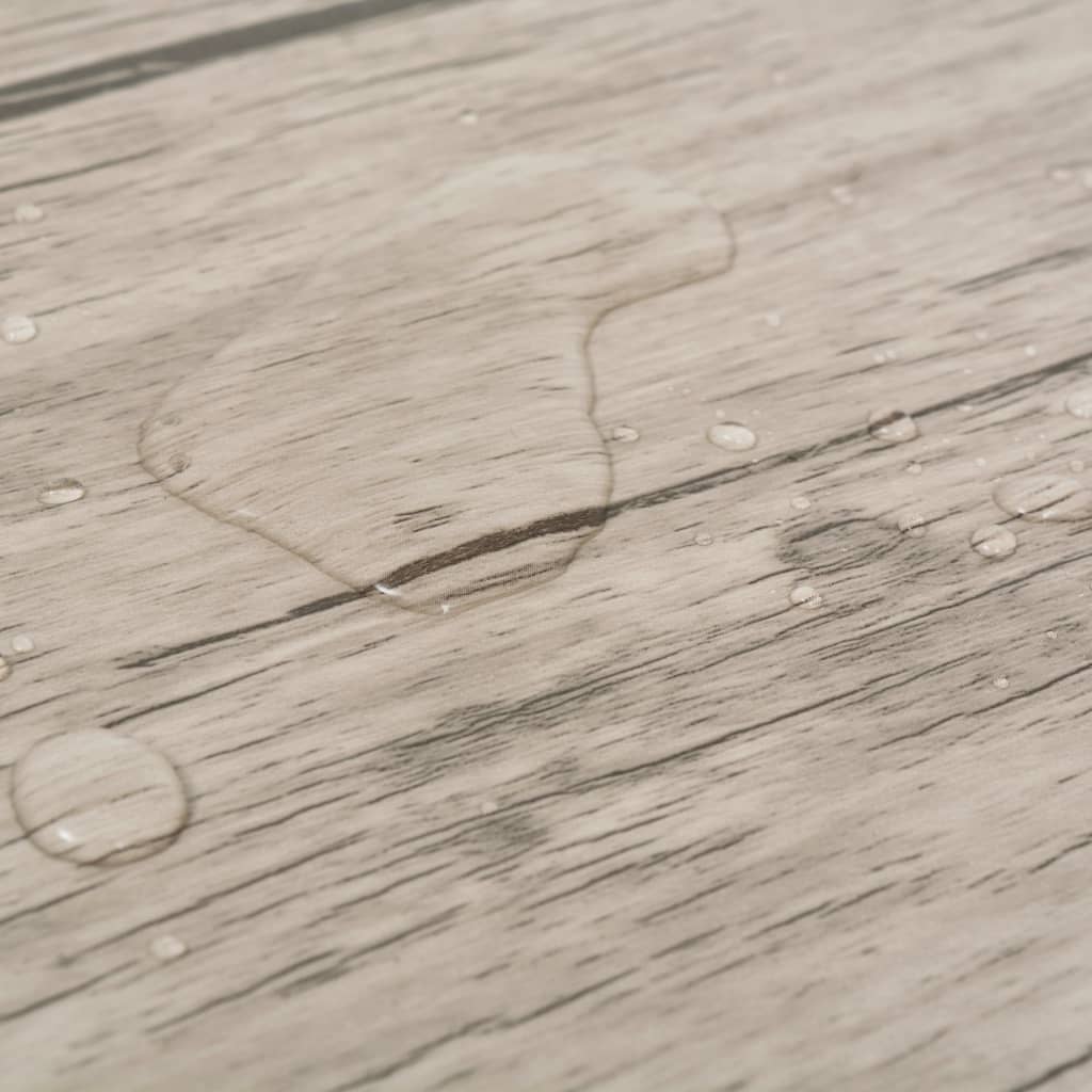 Water droplets on oak washed self-adhesive PVC flooring, showcasing its durability and water resistance.