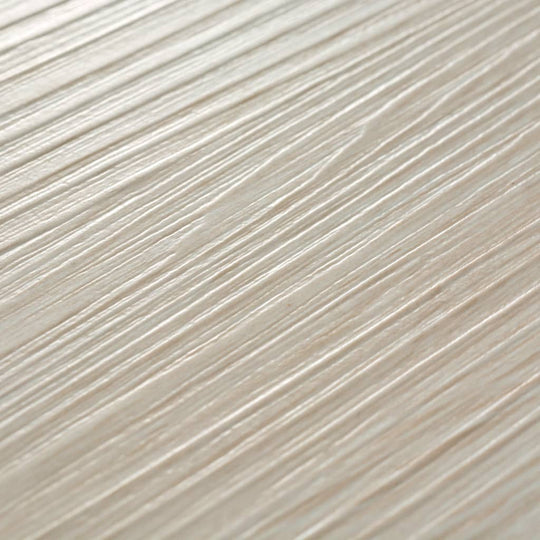 Close-up of oak classic white self-adhesive PVC flooring planks with textured wood grain pattern.