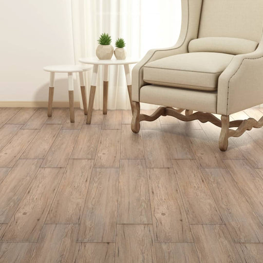 Cozy living space featuring self-adhesive PVC flooring planks in oak brown, styled with a beige chair and small table.