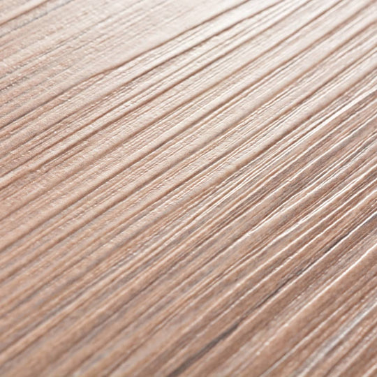 Close-up of self-adhesive PVC flooring planks in oak brown with natural wood-like texture.