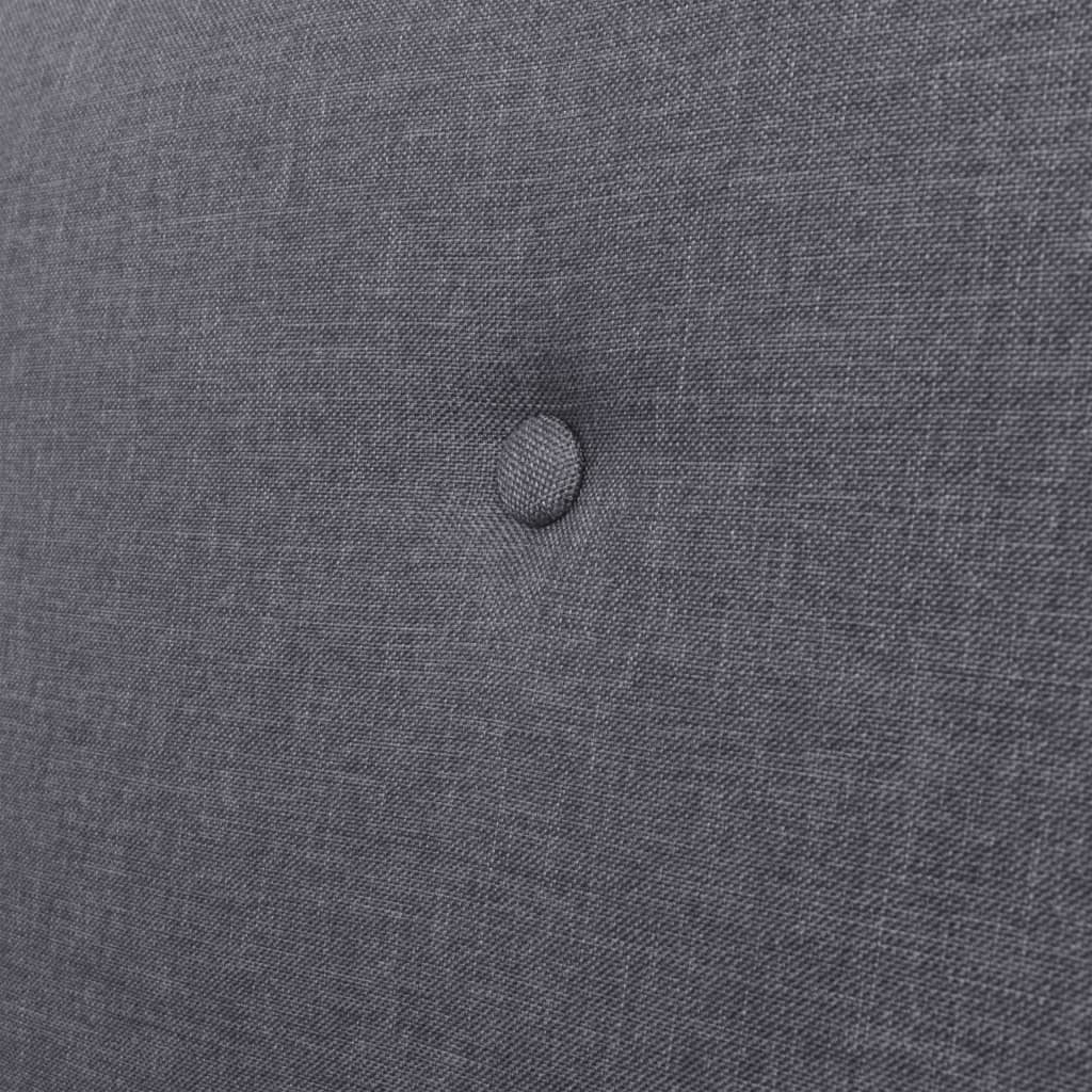 Close-up of dark grey fabric upholstery with button tufting, ideal for comfortable armchairs and stylish furniture.