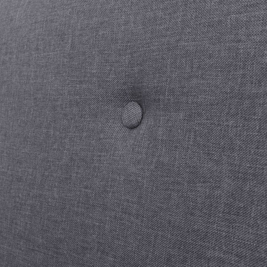 Close-up of dark grey fabric upholstery with button tufting, ideal for comfortable armchairs and stylish furniture.