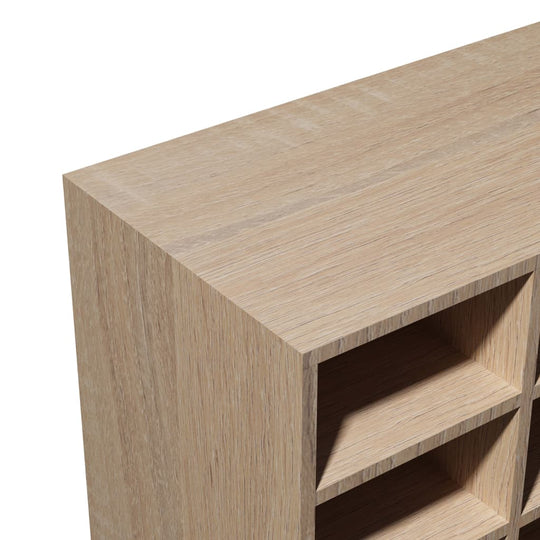 Close-up of the engineered wood surface of an oak shoe rack, showcasing its texture and compartments.