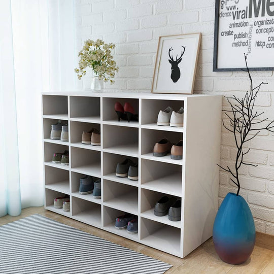 Modern white shoe rack with 20 compartments, organized shoes, decorative elements, and stylish decor in bright living space.