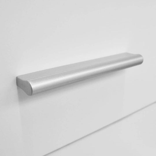 Close-up of sleek silver handle on a white tall chest of drawers, showcasing modern furniture design and functionality.