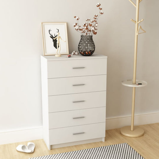 Modern white storage cabinet with five drawers and decorative items on top, ideal for furniture arrangement in any room.