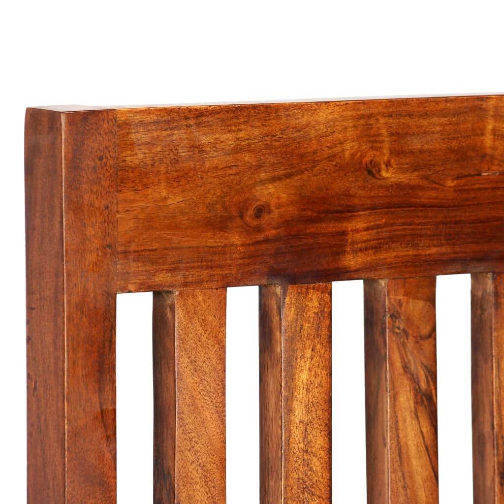 Close-up of solid acacia wood dining chair backrest with honey finish, showcasing unique wood grains.