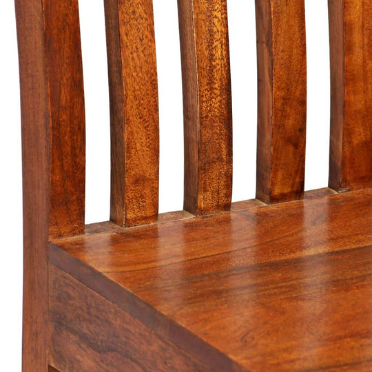 Close-up of solid acacia wood dining chair with honey finish, highlighting the unique grain and modern design.