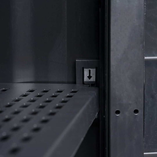 Close-up of adjustable ventilated shelf in a black garden storage cabinet, showcasing its durable polypropylene structure.