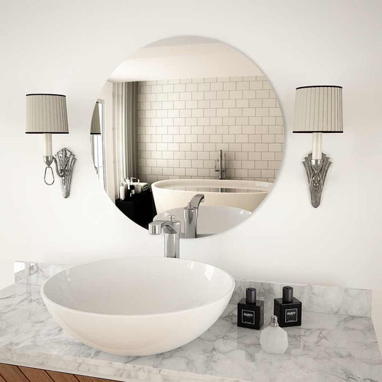 Modern 60 cm round wall mirror above a stylish vessel sink, enhancing minimalistic bathroom decor.