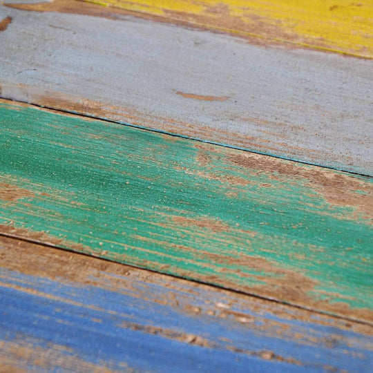 close-up of colorful reclaimed wood planks, showcasing vibrant greens, blues, and yellows, ideal for outdoor furniture design.