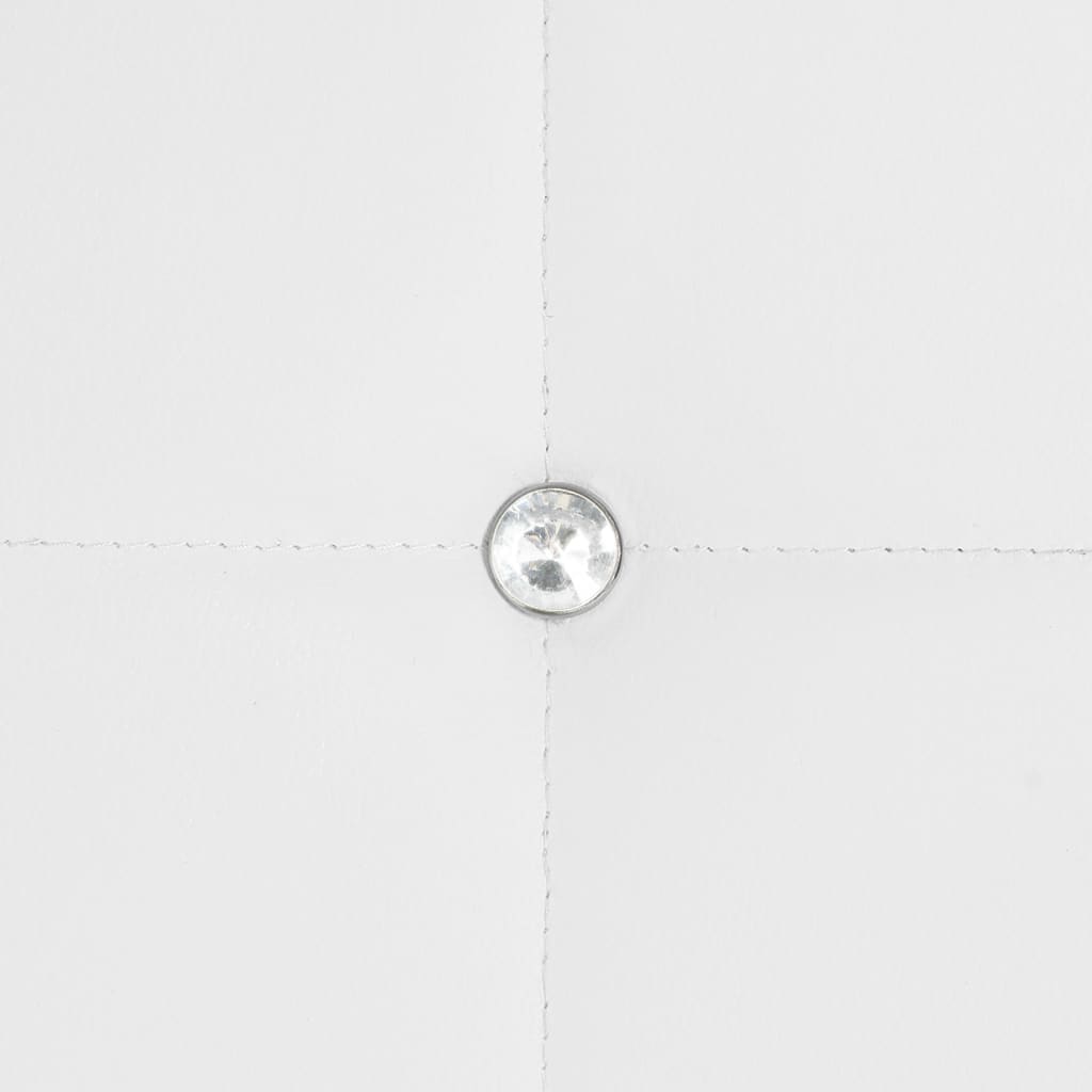 Close-up of a decorative crystal button on white faux leather upholstery for dining chairs.