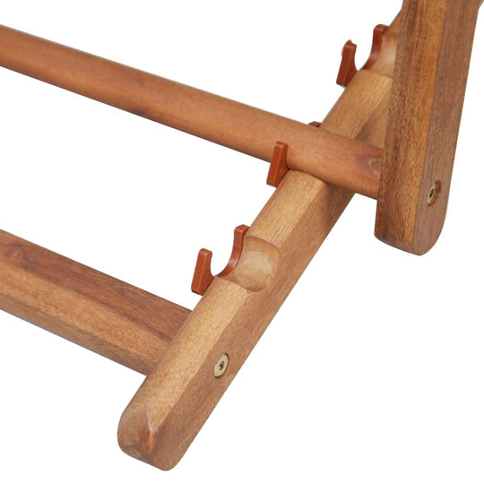 Close-up of the sturdy wooden frame of a folding beach chair, showcasing its durable construction and design.