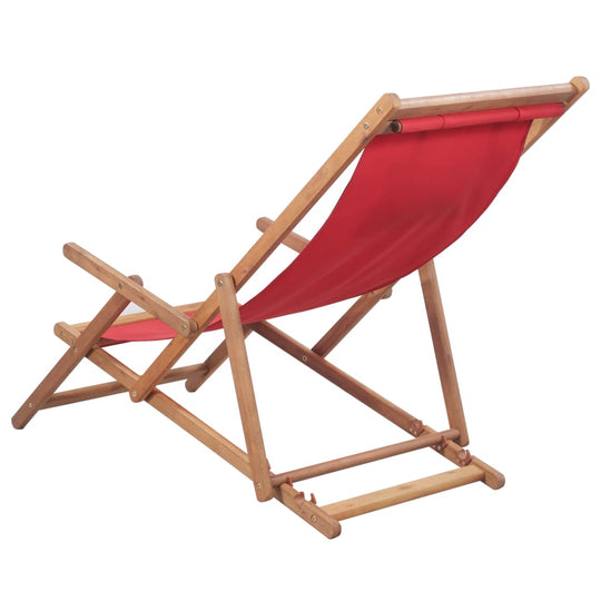 Folding beach chair with red fabric seat and wooden frame, perfect for outdoor relaxation and camping.
