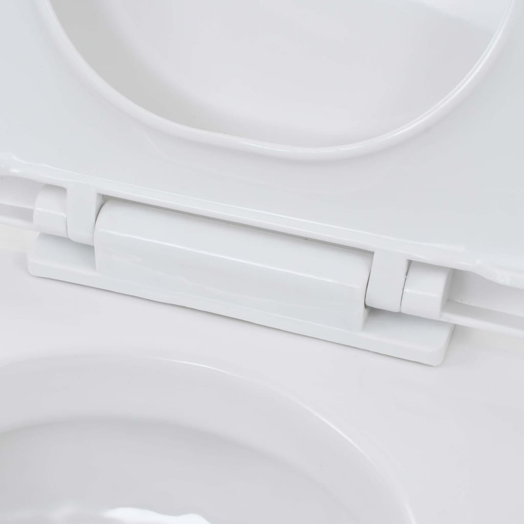 Close-up of the soft-close hinge on a white ceramic wall-hung toilet lid, showcasing its modern design and functionality.