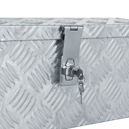 Close-up of the lock and hinge of a silver aluminium box with a diamond pattern design, ideal for storage and transport.