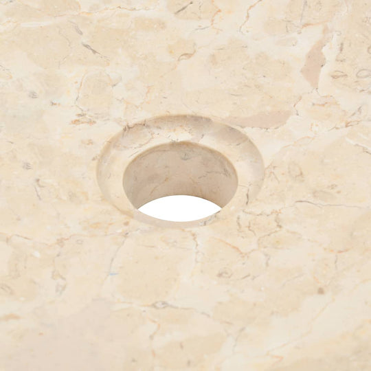 Close-up of a cream marble sink showing a sleek, smooth surface with a drain hole, ideal for modern bathrooms.