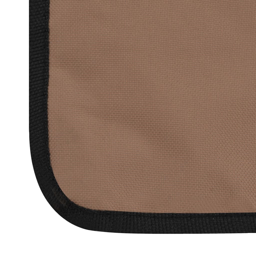 Brown fabric corner of a folding beach mat with black trim, perfect for outdoor relaxation and sunbathing.
