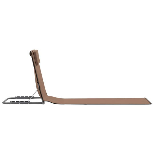 Folding beach mat with adjustable backrest and headrest, ideal for relaxing outdoors.
