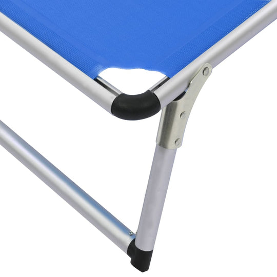 Close-up of a blue folding sun lounger featuring a sturdy aluminum frame and seamless textilene material.