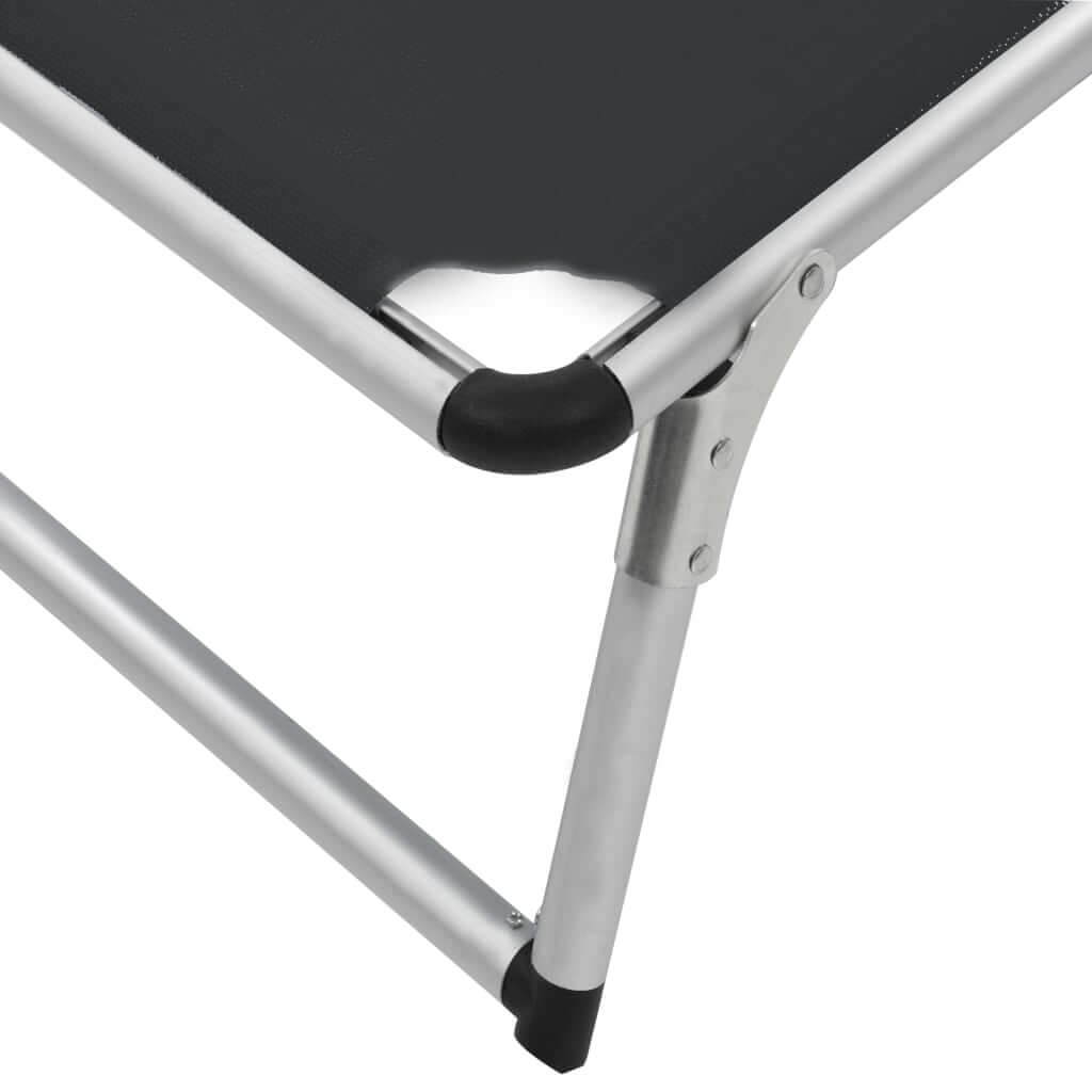 Close-up of a folding sun lounger showing the aluminium frame and textilene fabric for durability and comfort.
