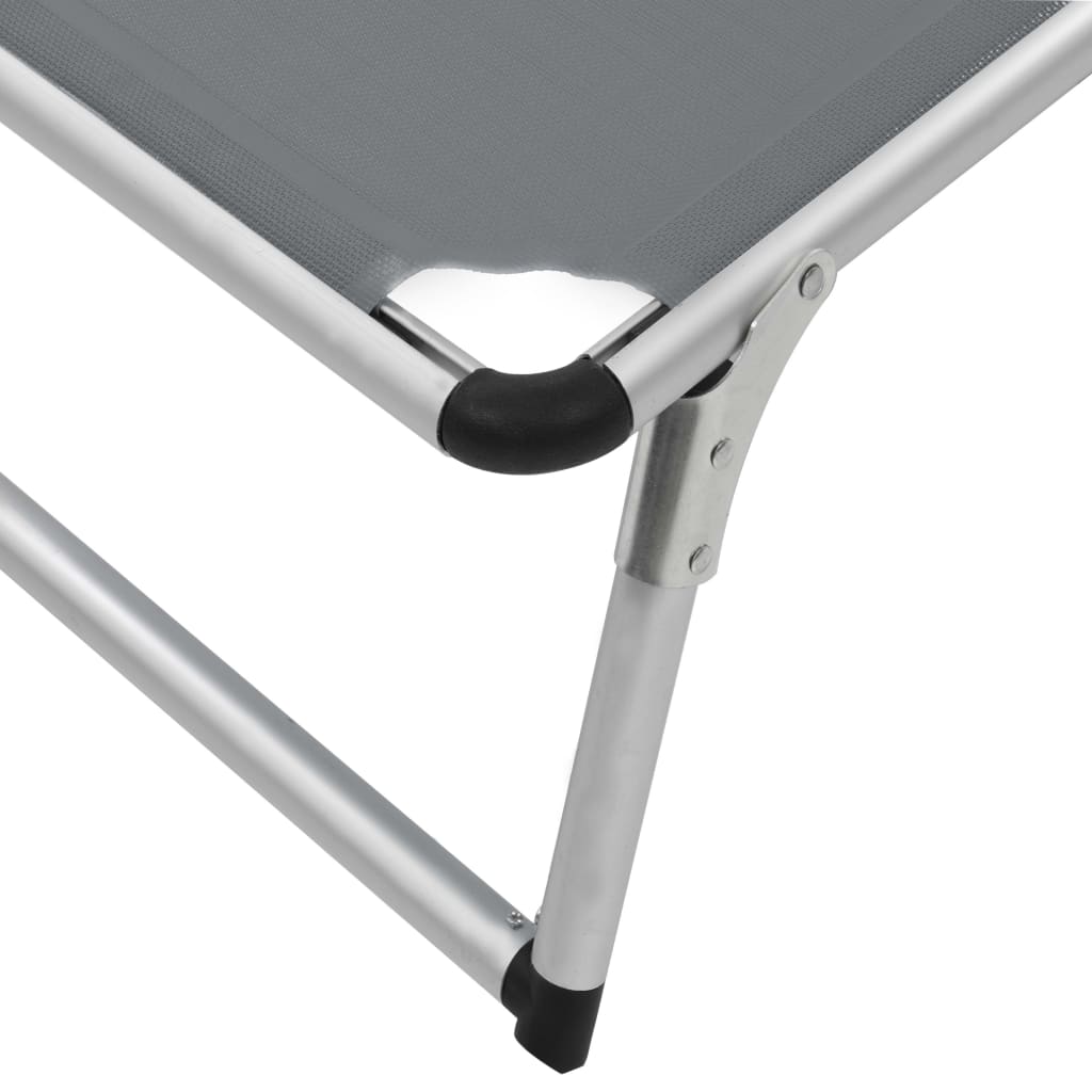 Close-up of a folding sun lounger with a durable aluminium frame and textilene fabric, highlighting the adjustable backrest.