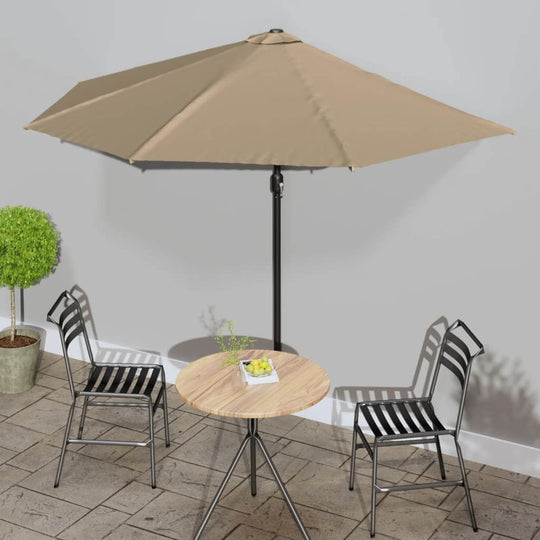 Balcony parasol with taupe cover and aluminum pole, providing shade over a round table and two chairs in an outdoor setting.