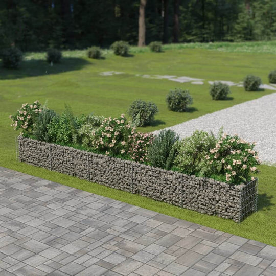 Gabion raised bed made of galvanised steel, filled with plants, enhancing outdoor furniture and garden aesthetics.