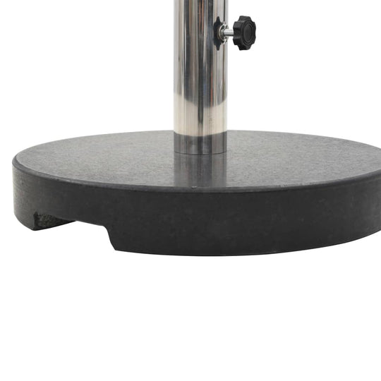 Round black granite parasol base with sturdy pole holder, ideal for outdoor furniture and umbrellas.
