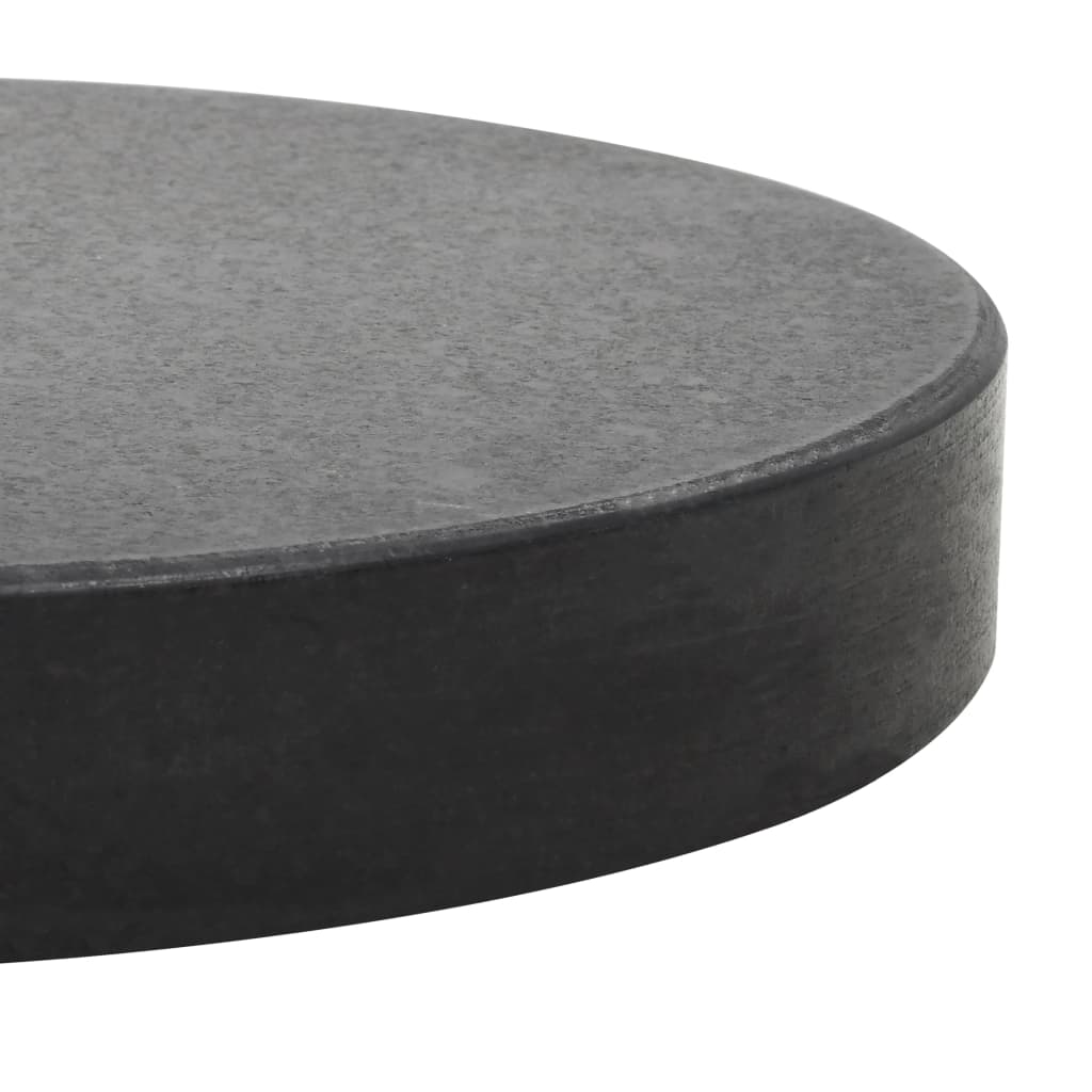 Close-up of a round black granite parasol base, designed for outdoor furniture stability and durability.
