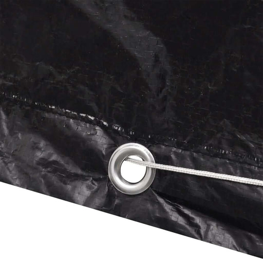 Close-up of black polyethylene garden furniture cover showing aluminium eyelet and fastening rope for secure fit.