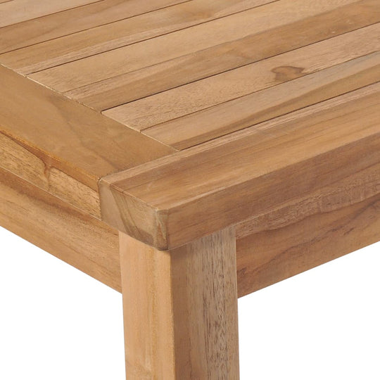 Close-up of a solid teak wood garden table surface showcasing its smooth finish and natural grain pattern.