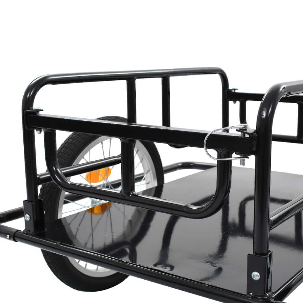 Close-up of a sturdy black bike trailer with two wheels, ideal for transporting luggage or outdoor furniture securely.