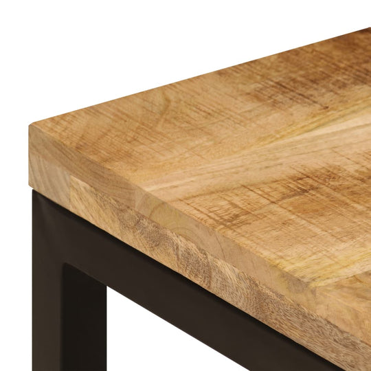 Close-up of solid mango wood surface on a stylish coffee table with black steel legs, showcasing natural grain and durability.