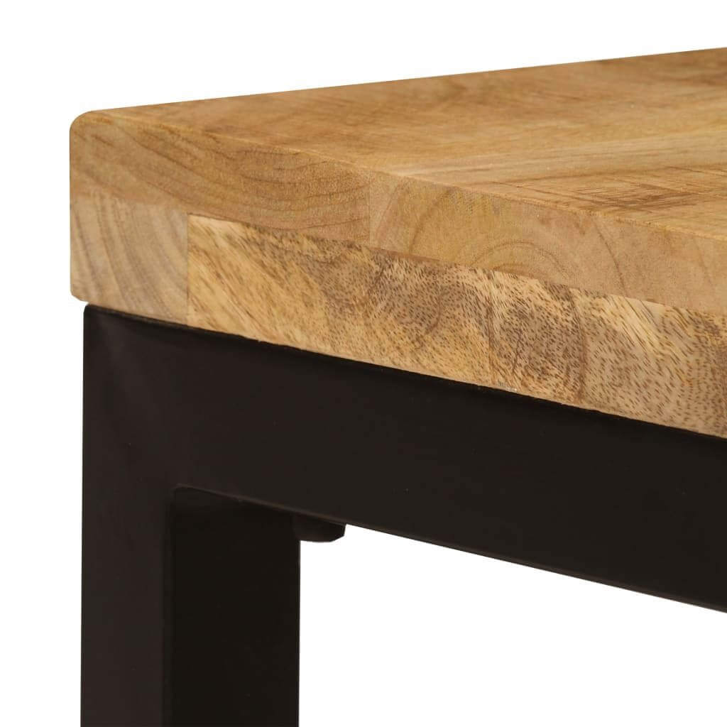 Close-up of solid mango wood top on a stylish coffee table with a sturdy black steel frame, showcasing modern furniture design.