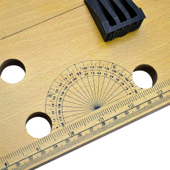 close-up of a workbench surface featuring a ruler and protractor for precise measurements and accurate cuts