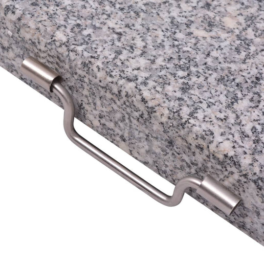 Stainless steel handle on a polished granite parasol stand for easy transportation in outdoor furniture.