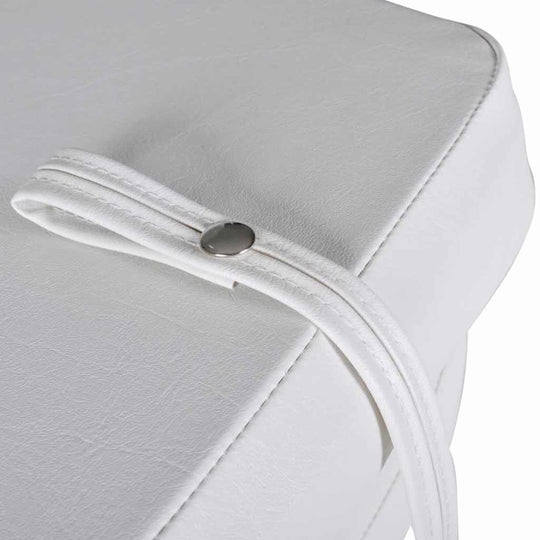 Close-up of a white boat seat with a strap and snap fastener, showcasing its durable waterproof material and design features.