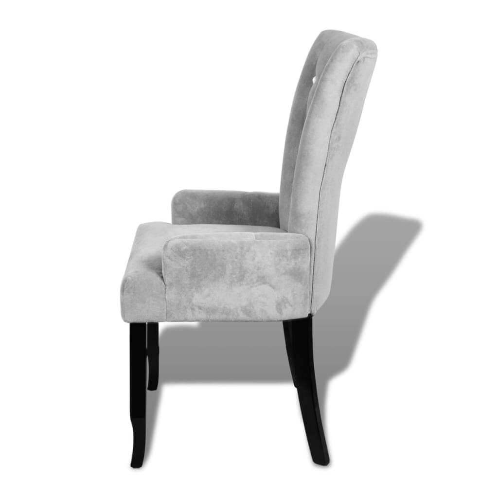 Side view of a silver velvet armchair with ergonomic design and black wooden legs, ideal for stylish lounge or outdoor furniture.