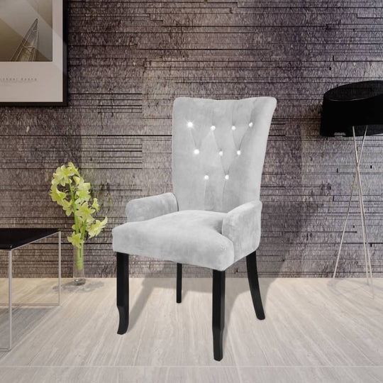 Elegant silver velvet armchair with button detailing, perfect for lounge and outdoor furniture settings.