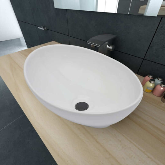 Luxury white oval-shaped ceramic basin on a wooden countertop, ideal for modern bathroom designs.