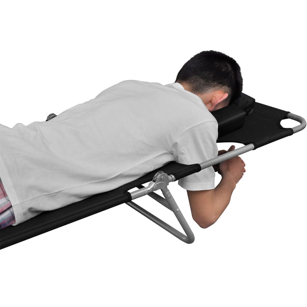 Man relaxing on a folding sun lounger with head cushion, showcasing adjustable backrest and durable design.