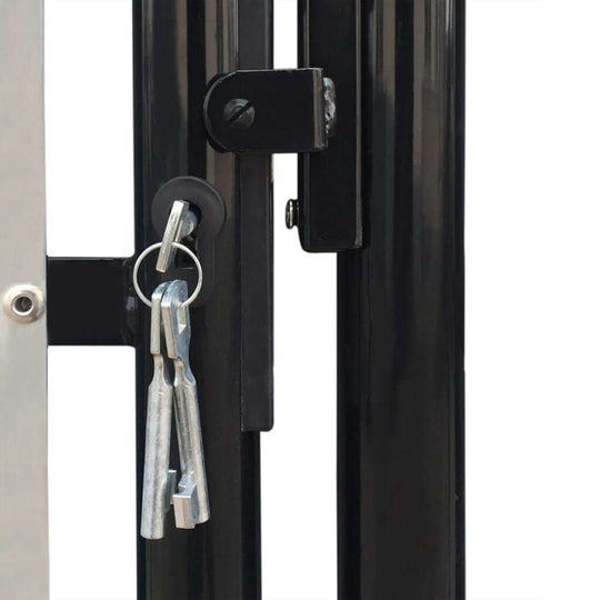 Close-up of the secure locking mechanism on a black single door fence gate with key.