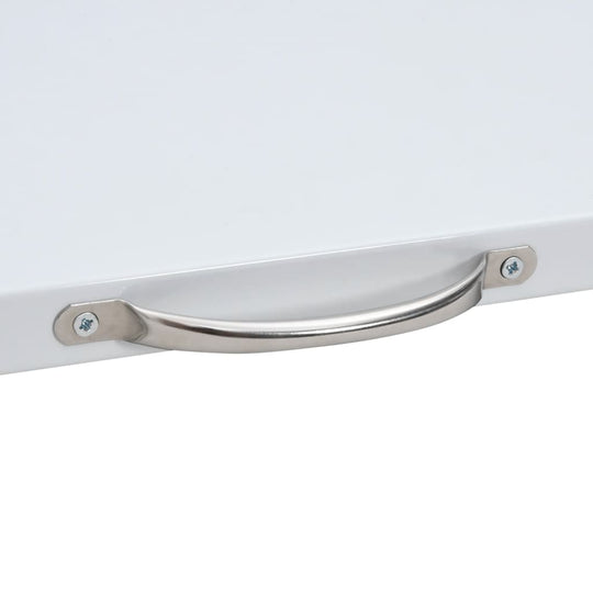 Close-up of a stainless steel handle on a white pull-out shelf for a washing machine stacking kit.